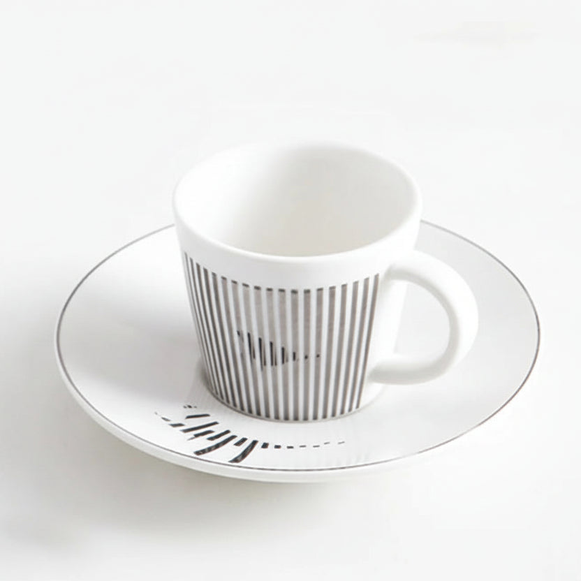 White ceramic cup and saucer with striped design on a white background, labeled 'Hummingbird 220ml'.