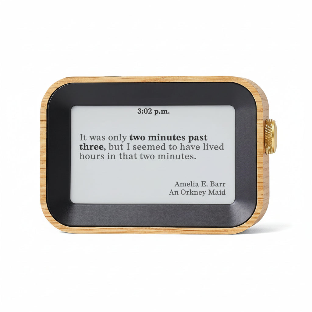 Digital clock with wooden frame displaying a quote by Amelia E. Barr.